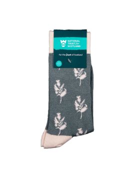 A pair of green socks with a thistle pattern and white toes. They have a label that says 'Men's Bamboo Socks.'