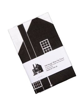 The tea towel featuring the Hill House West Elevation with a label that says 'Hill House West Tea Towel. A natural 100% cotton tea towel hand screen printed. Made in the UK.'