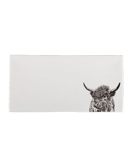 A white tray with an illustration of a Highland Cow in the right hand corner.